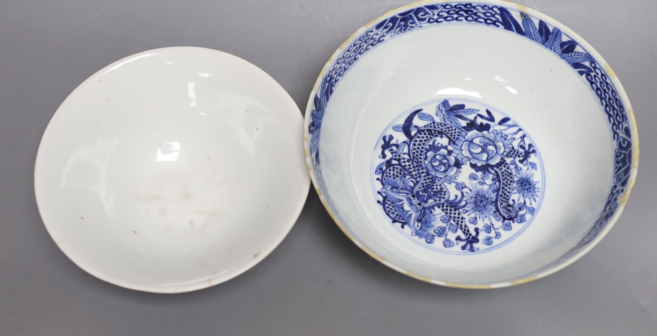 A Chinese blue and white dragon bowl, another blue and white bowl and a saucer, 19th century, largest 20.5cm